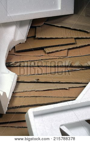 Background Image With A Lot Of Beige Cardboard Paper And Styrofoam Boxes Disgarded As Rubbish. The C