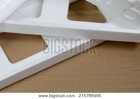 Background Image With Beige Cardboard Paper And Styrofoam Boxes Disgarded As Rubbish. The Concept Of