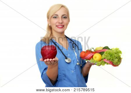 Beautiful female doctor with a dietician with fruit isolated on white background