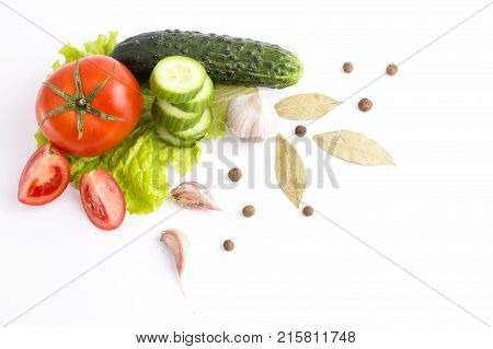 Tomato peppers with tomatoes on a white background. Fresh vegetables on a white background. Composition from vegetables. Red and yellow peppers on white background with garlic. Tomato with peppers and cucumber on a white background.