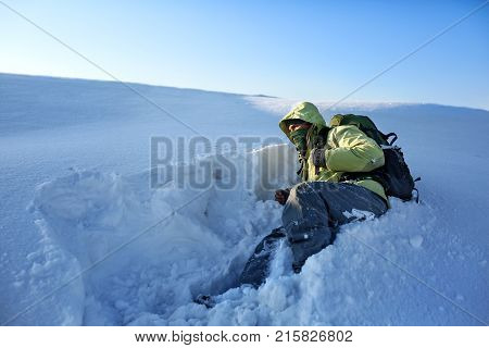 Climber in a snow storm. Man in mountains