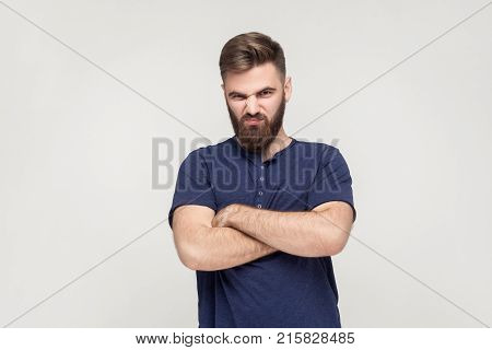 Resentful Man, With Arms Folded, Over Gray Background