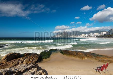 Scenic panoramic view of Ipanema Beach from the rocks at Arpoador with Rio de Janeiro skyline Brazil