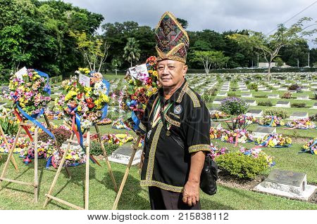 Labuan,Malaysia-Nov 12,2017:Kadazandusun man in traditional costumes attending the Remembrance Day Lest We Forget at Commonwealth World War II graveyard in Labuan,Malaysia.
