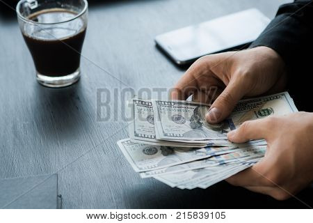 hand recount dollars. the man counts the money. new hundred-dollar bills