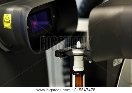 The Worker Measures The Size Of The Particles And Drops Of The Spray. Pharmaceutical Industry And La