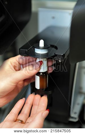 The Worker Measures The Size Of The Particles And Drops Of The Spray. Pharmaceutical Industry And La