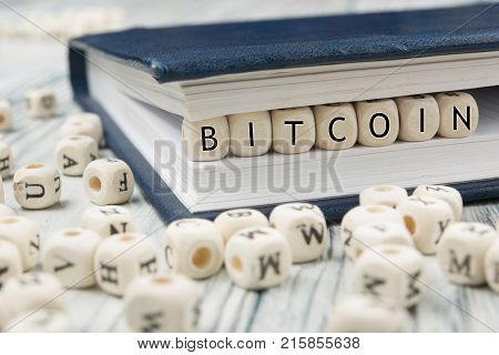 Bitcoin word written on wood block. New virtual money