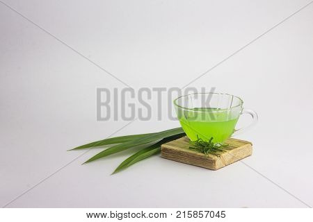 Glass Of Cold Pandan Juice - Healthy Food Against Wood,.with Pandan Green.on A White Background