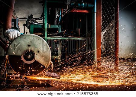 Worker are using electric cutting steel machine background