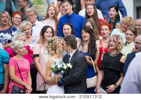 Belarus Gomel Wedding houseJuly 29 2017.The bride and groom kissing after the registry office.Wedding day The bride and groom.Gosts at the wedding. The relatives of the bride and groom