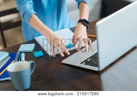 Young schoolboy. Close up of a workspace of a cute nice young boy while studying a home