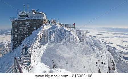 LOMNICKY STIT SLOVAKIA - FEBRUARY 27: People on the top of the hill Lomnicky peak in High Tatras mountains on February 27 2013 in Lomnicky stit