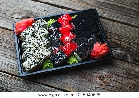 Sushi In A Black Container On A Wooden Table Colorful And Beautiful
