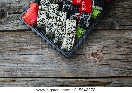 Sushi In A Black Container On A Wooden Table Colorful And Beautiful