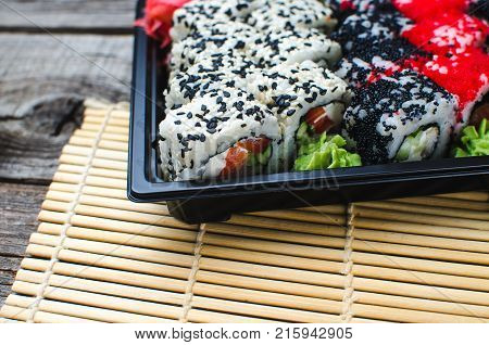 Sushi In A Black Container On A Wooden Table Colorful And Beautiful