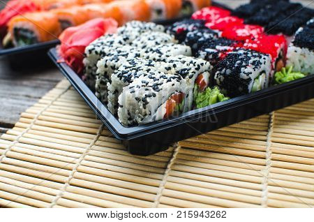 Sushi In A Black Container On A Wooden Table Colorful And Beautiful