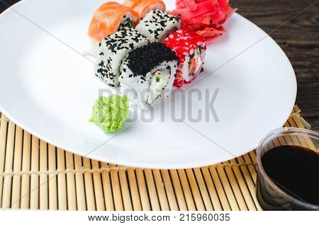 On The Plate Is White, Lined With Different Rolls, Sushi