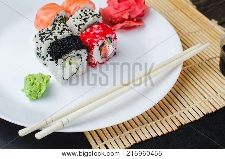 On The Plate Is White, Lined With Different Rolls, Sushi