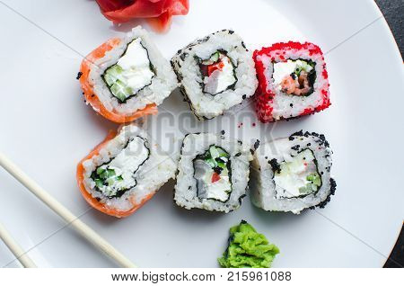 On The Plate Is White, Lined With Different Rolls, Sushi