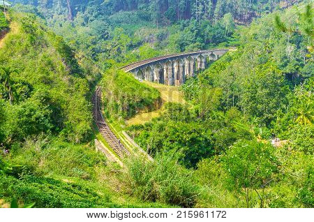 Nine Arch Bridge is one of main attractions of resort people come to watch the trains running through the lush jungle along the great stone construction Demodara Ella Sri Lanka.