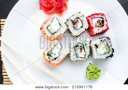On The Plate Is White, Lined With Different Rolls, Sushi
