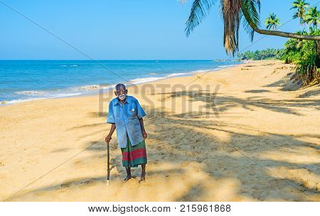BENTOTA SRI LANKA - DECEMBER 6 2016: The portrait of the elderly retired fisherman resting on the cozy sand beach on December 6 in Bentota.