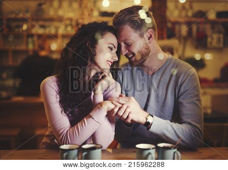 Young attractive couple together on date in bar