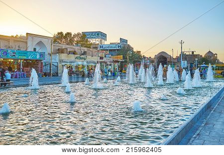 YAZD IRAN - OCTOBER 17 2017: Fountain on Amir Chakhmaq square is one of the most belowed place among locals in the evening on October 17 in Yazd
