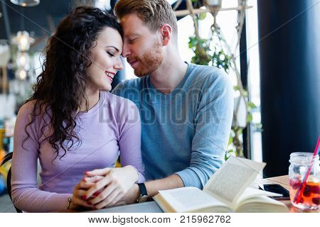 Young attractive couple on date in coffee shop
