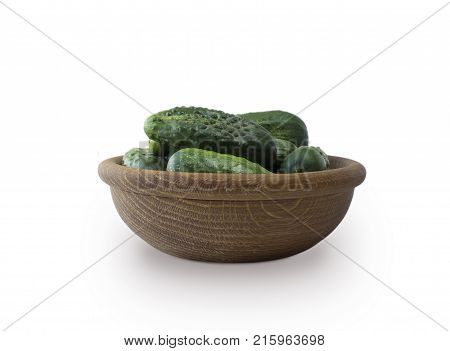 Fresh сucumbers in wooden bowl isolated on white background. Gherkin with copy space for text.