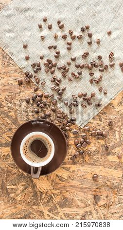 Drown Coffee cup. Greek coffee on wooden background. Turkish coffee and beans.