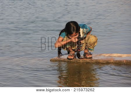 Khichan, India - February 12: An Unidentified Girl Drinks Water From Reservoir On February 12, 2011