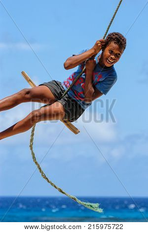 Lavena, Fiji - November 27: Unidentified Boy Swings On A Rope Swing On November 27, 2013 In Lavena V