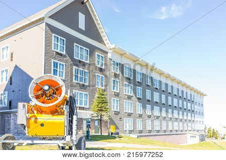 Closeup Of Orange Snow Maker Machine With Fan Blades Near Ski Resort Slope In Autumn, Fall