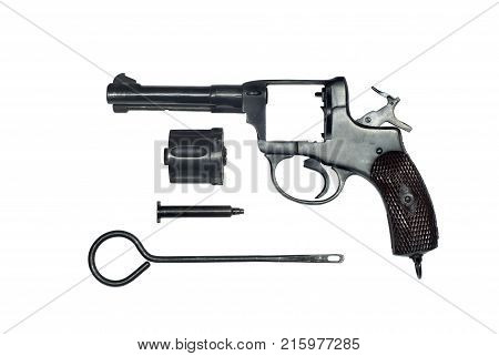 dismantled vintage revolver with the cylinder removed and the ramrod in the form of separate parts on a white background