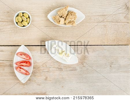 Top view of natural olives, tomatoes, feta and rusks. Mediterranean traditional healthy food. Greek food.