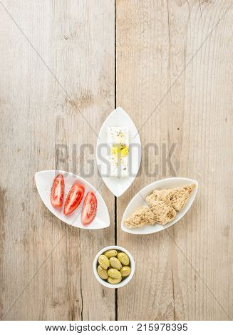 Top view of natural olives, tomatoes, feta and rusks. Mediterranean traditional healthy food. Greek food.