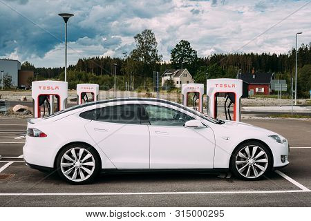 Tocksfors, Sweden- June 26, 2019: White Color Tesla Model S P85 Car Parked At Charging Station. The 