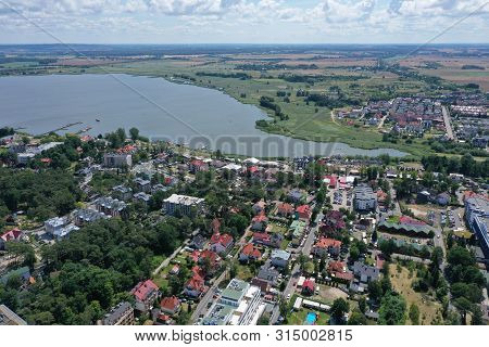 Drone Aerial Perspective View On Touristic City Center Located At Jamno Lake With Yacht Marina.