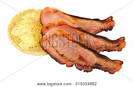 Grilled Bacon Rashers And Pikelet Crumpet Isolated On A White Background