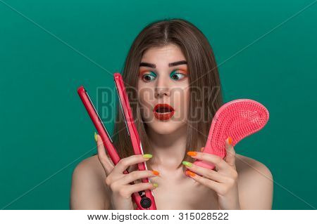 Portrait Of Surprised Beautiful Young Woman With Bright Color Make-up Doing Hair Style Herself With 