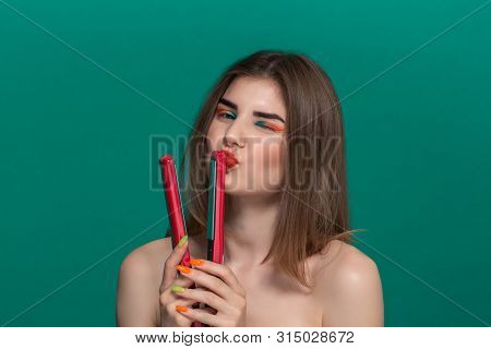 Portrait Of Beautiful Young Woman With Bright Color Make-up Doing Hair Style Herself With A Purple S