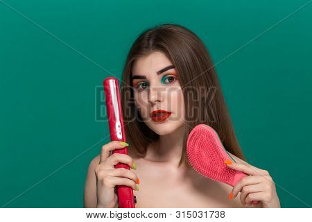 Portrait Of Beautiful Young Woman With Bright Color Make-up Doing Hair Style Herself With A Purple S