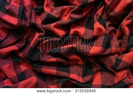 Wrinkled Black And Red Cell Clothes Background. Fabric With Black Red Cages Pattern. Plaid Material.