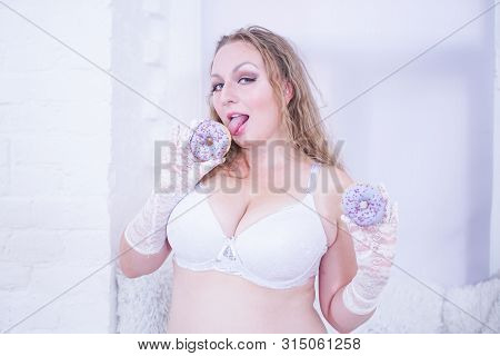 Playful Funny Plus Size Woman In Lingerie With Two Donuts