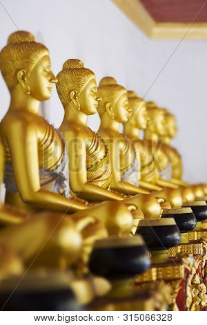 Golden Statues In A Buddhist Temple. Thailand. Quietly Sit, Meditate. Religious And Philosophical Do