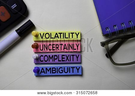 Volatility Uncertainly Complexity Ambiguity - Vuca Text On Sticky Notes Isolated On Office Desk