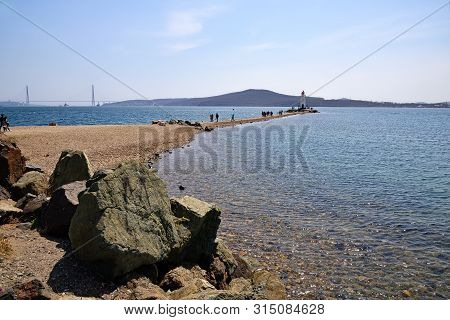 Vladivostok, Russia - April 28, 2019: Beautiful View On The Bosporus Eastern, White Lighthouse Tokar