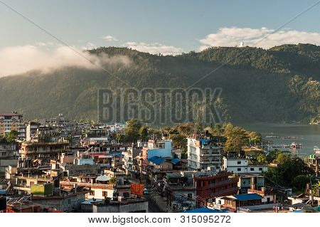 Landscape With Pokhara Rooftops On Sunrise With Annapurna South, Hiunchuli And Machapuchare Fishtail